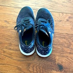 Black and gold Nikes